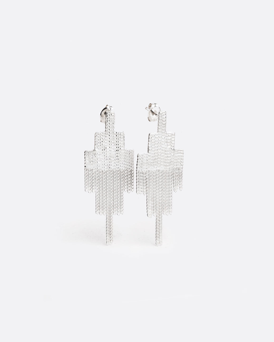 two silver earrings that are in the shape of squares that have been stacked in a pyramid like shape. the top half of the earring is solid, and the bottom half is made of chain that moves with the wearer.