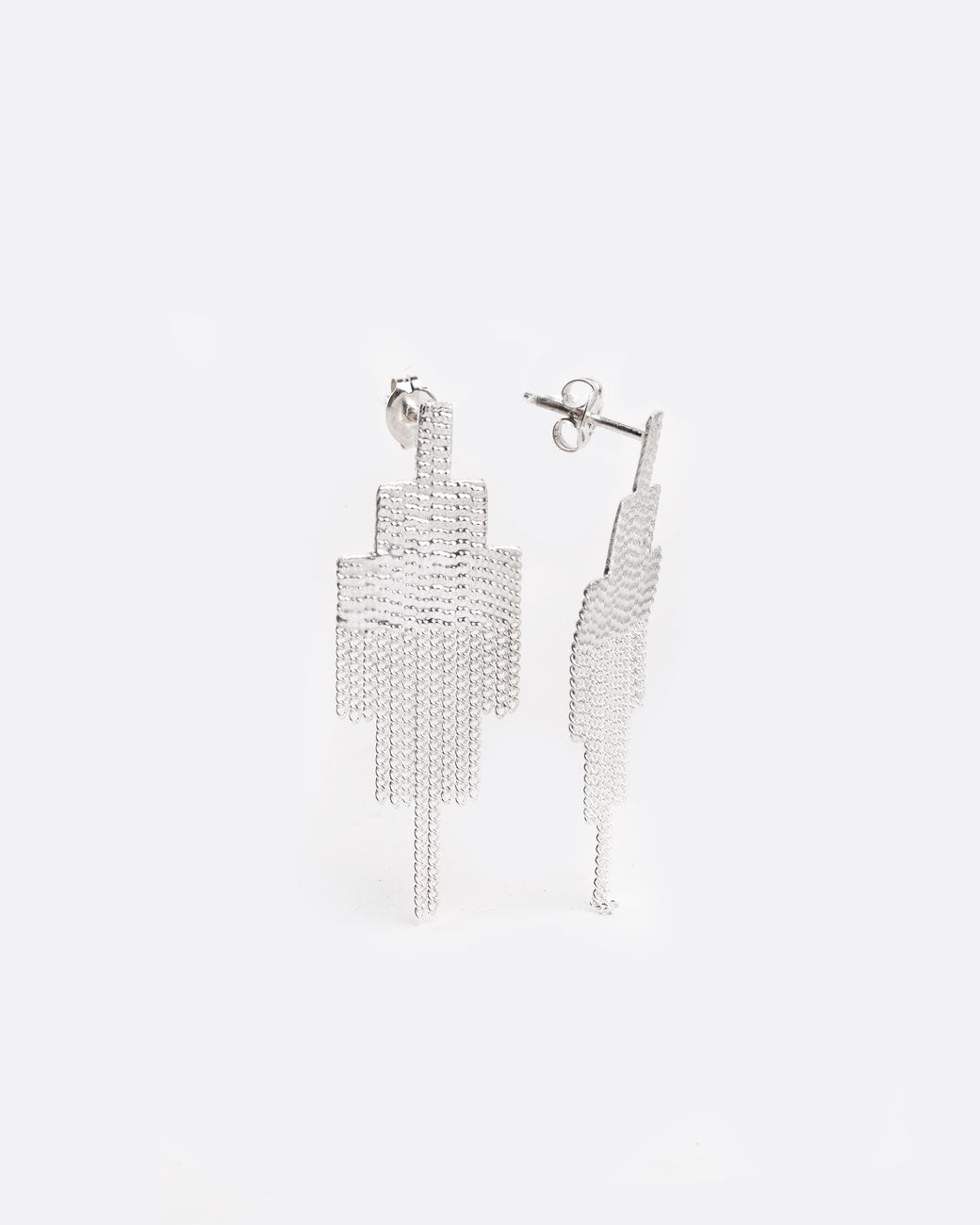 two silver earrings that are in the shape of squares that have been stacked in a pyramid like shape. the top half of the earring is solid, and the bottom half is made of chain that moves with the wearer. the right earring is on a 45 degree angle and you can see the silver butterfly back on the post at the top. 