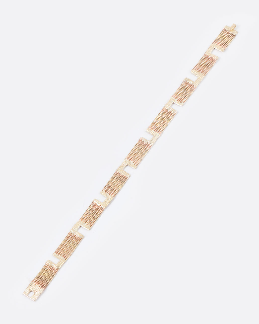 overhead angled flatview of a hannah keefe bracelet with 14k yellow gold chain strands soldered together in equal length sections by alternating gold solder opened squares creating a sort of maze of chain and gold solder