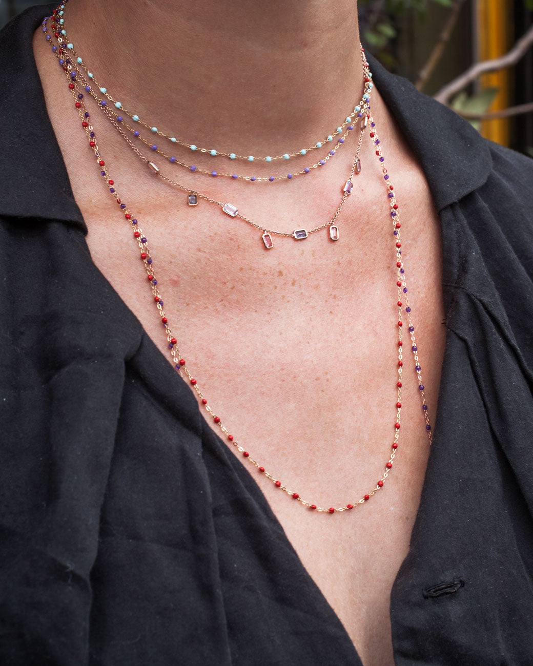 gold chain with 9 emerald cut sapphires set horizontally and vertically along the chain