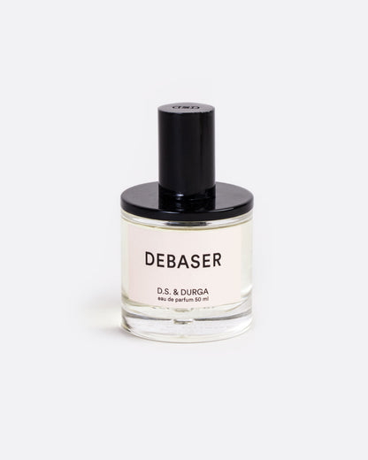 A glass bottle with a label that reads: Debaser D.S. & Durga eau de parfum 50 ml with black shiny spritzer top. Shown from the front.