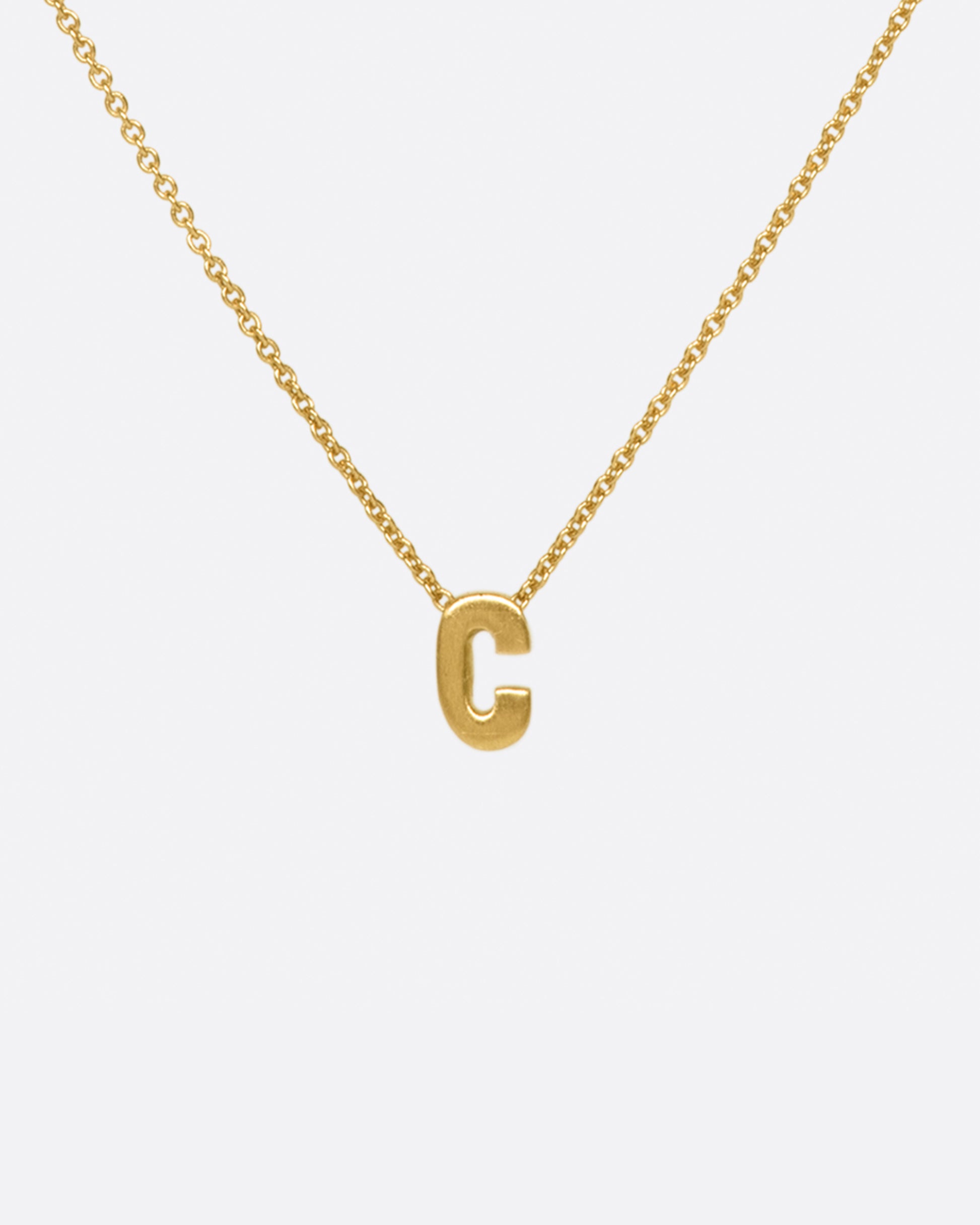 This micro initial necklace features a block letter of your choice hanging from a cable chain with an optional separate bezel set diamond tag.