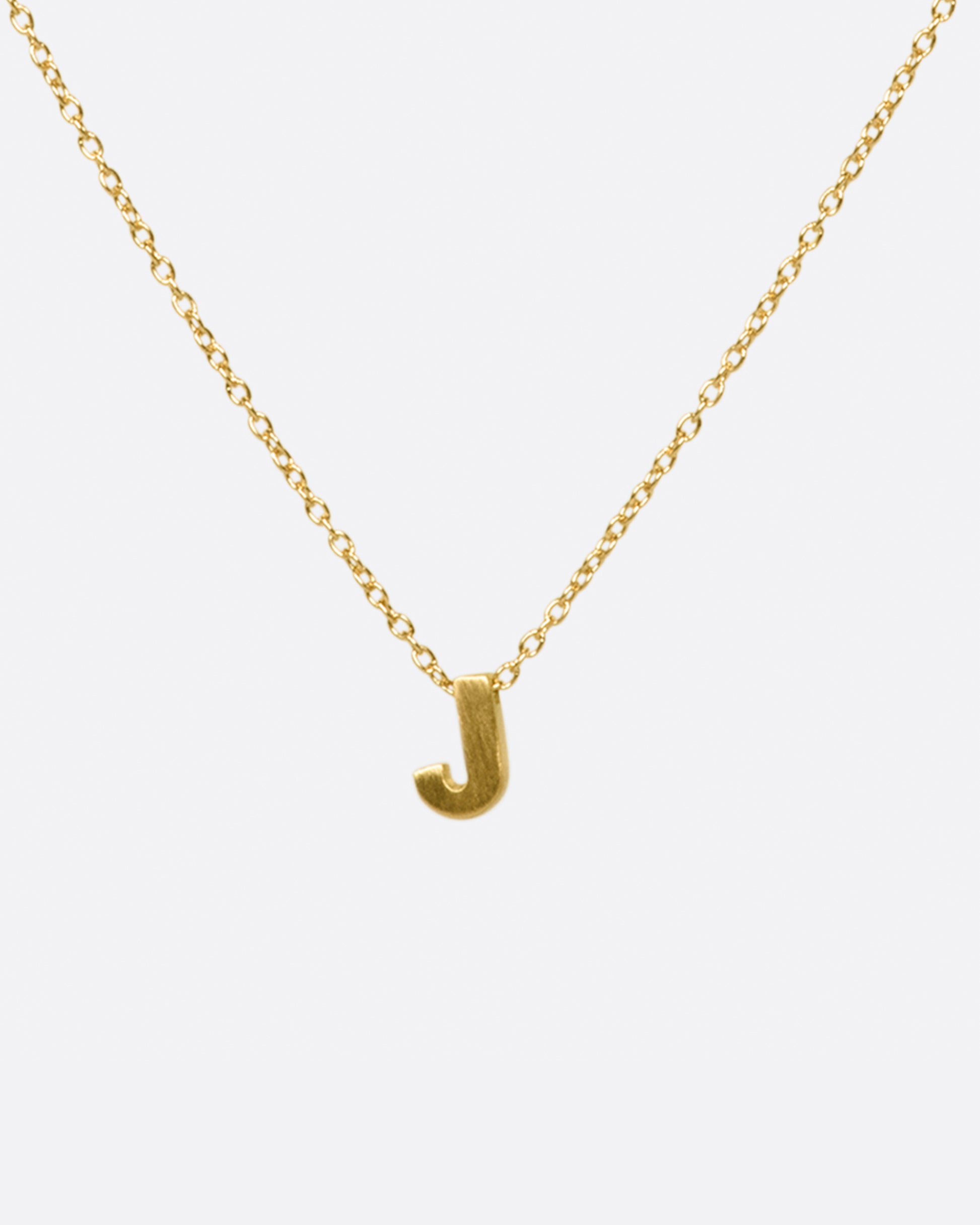 This micro initial necklace features a block letter of your choice hanging from a cable chain with an optional separate bezel set diamond tag.