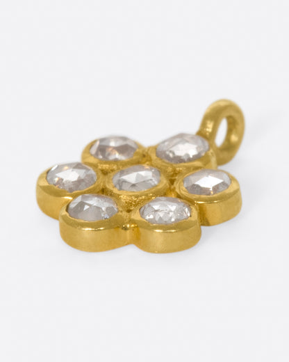 Yellow gold seven diamond flower charm, angled view of the bezels