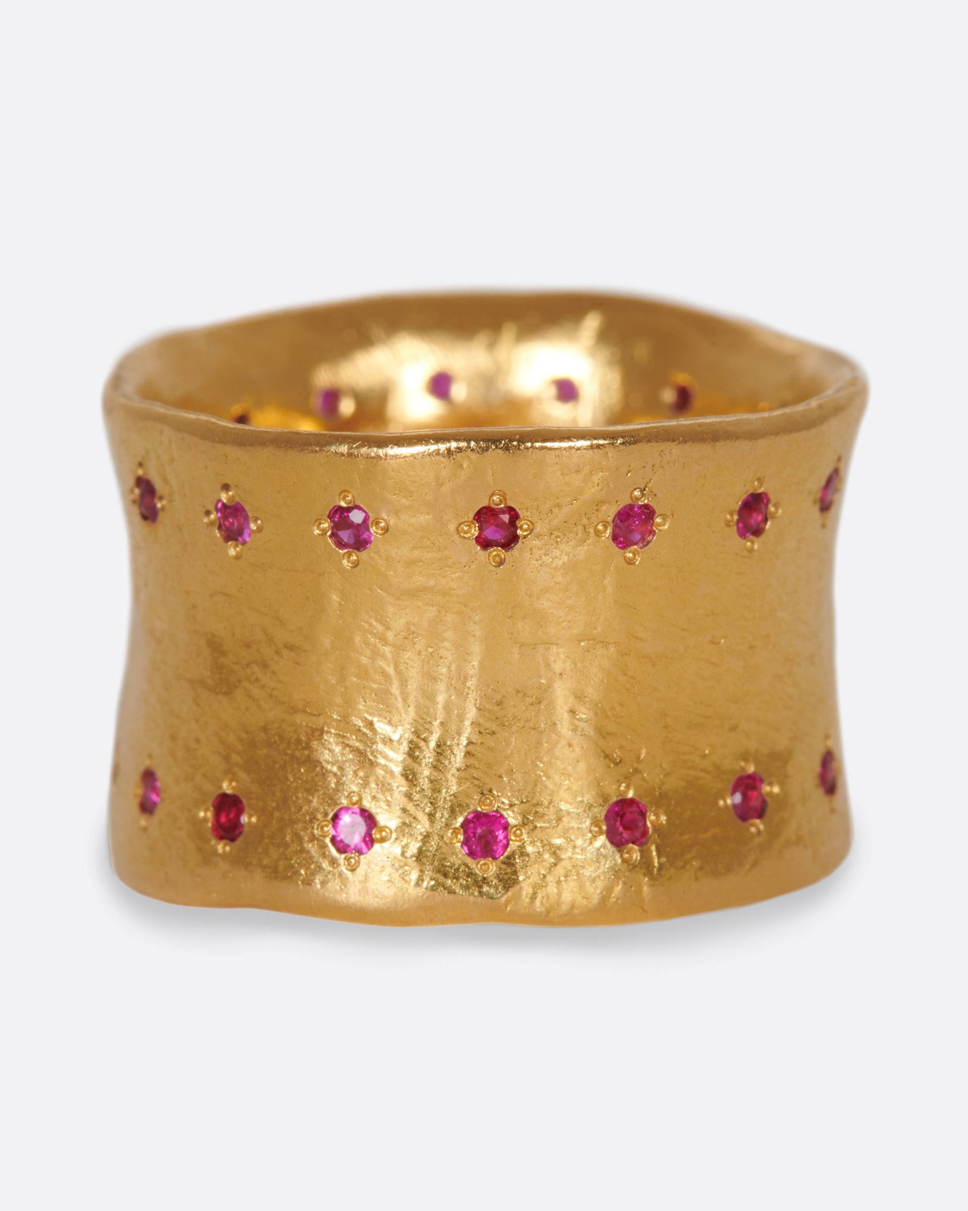 A slightly concave 22k gold band lined with thirty two rubies.