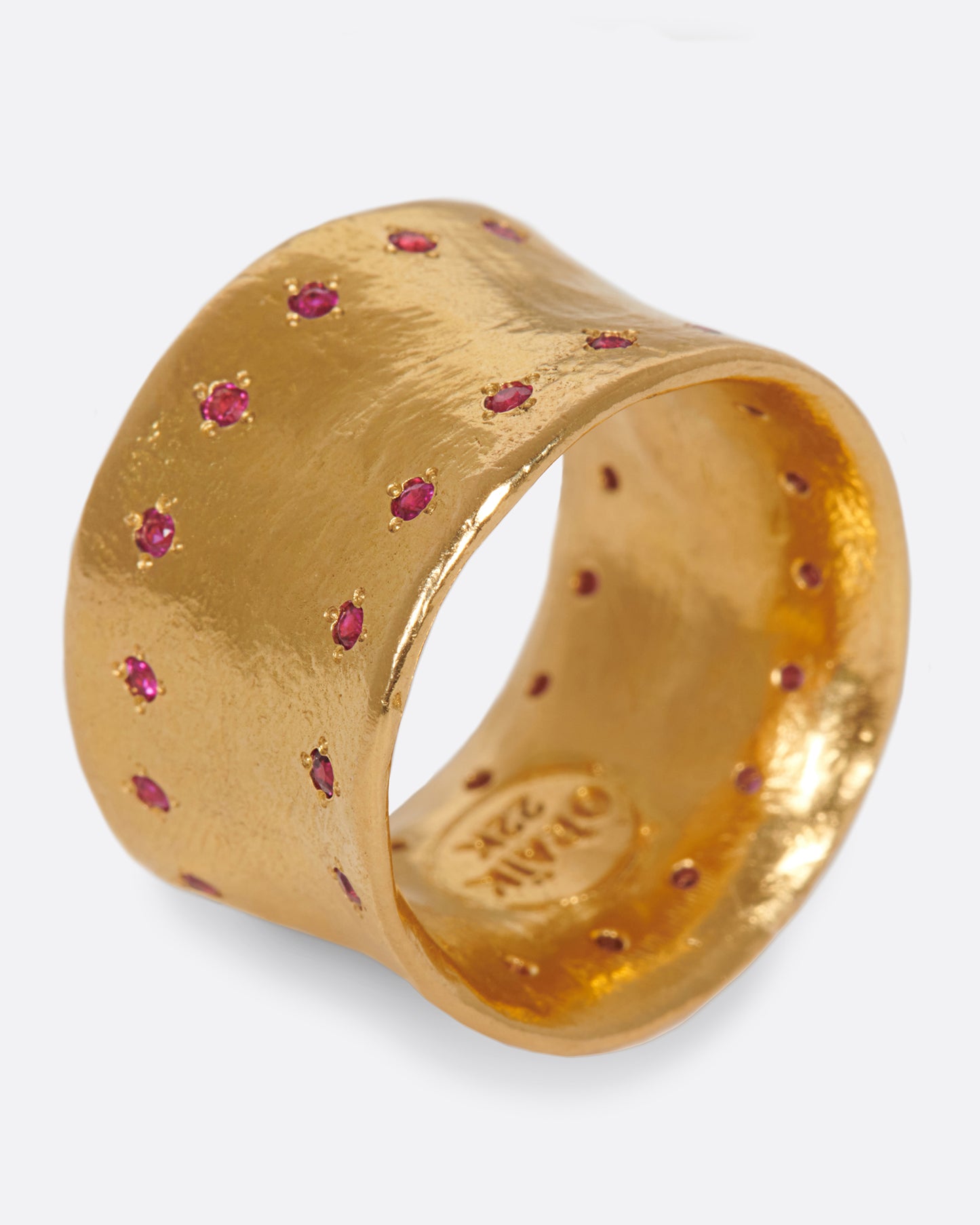 A slightly concave 22k gold band lined with thirty two rubies.