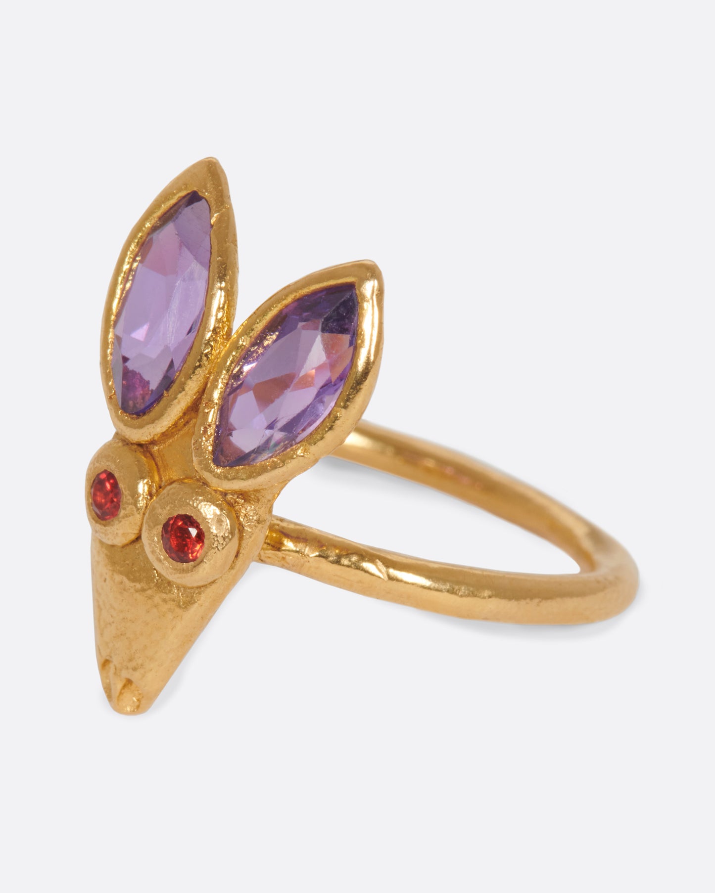 A little, hand-formed rabbit ring with big amethyst ears and red sapphire eyes.