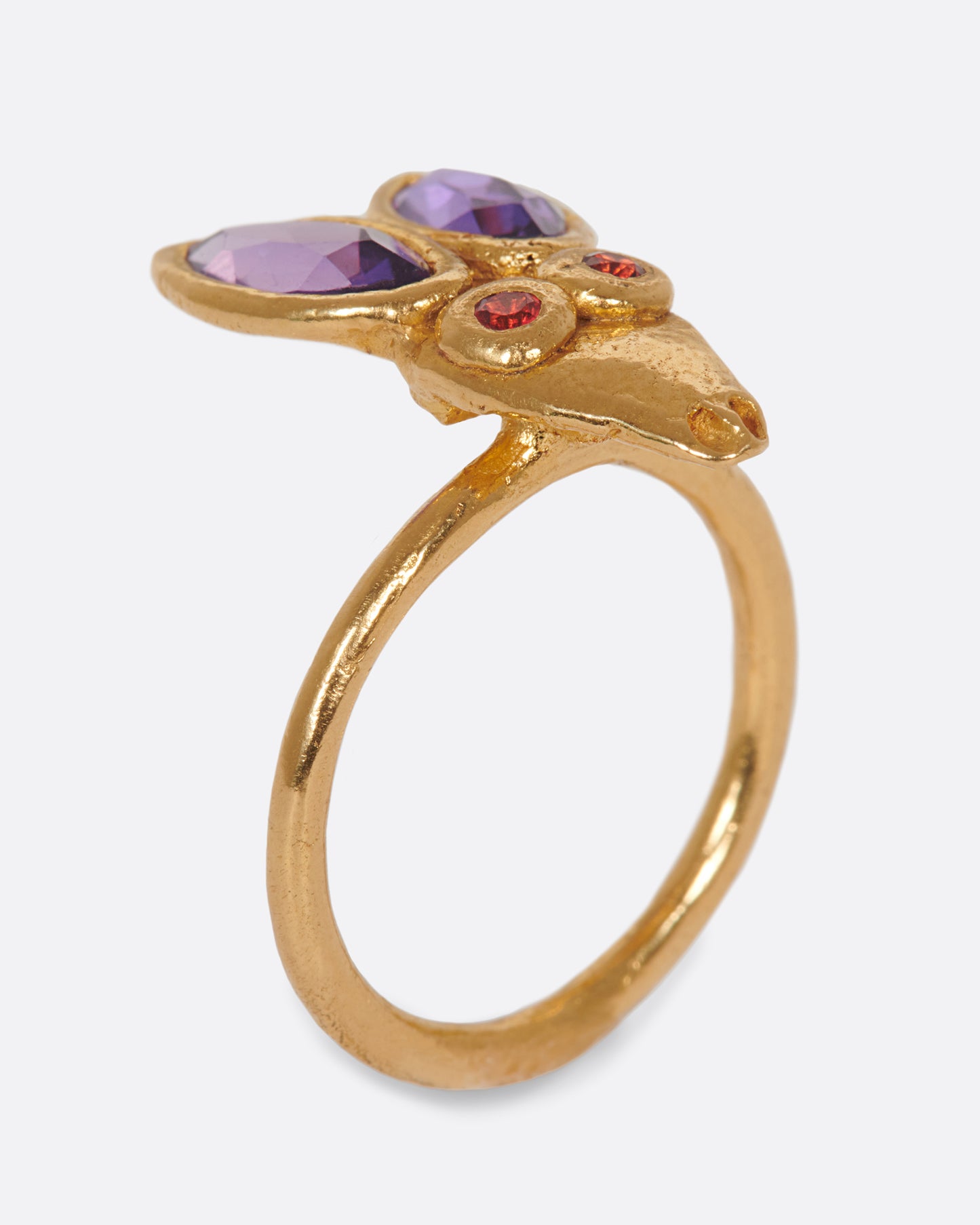 A little, hand-formed rabbit ring with big amethyst ears and red sapphire eyes.