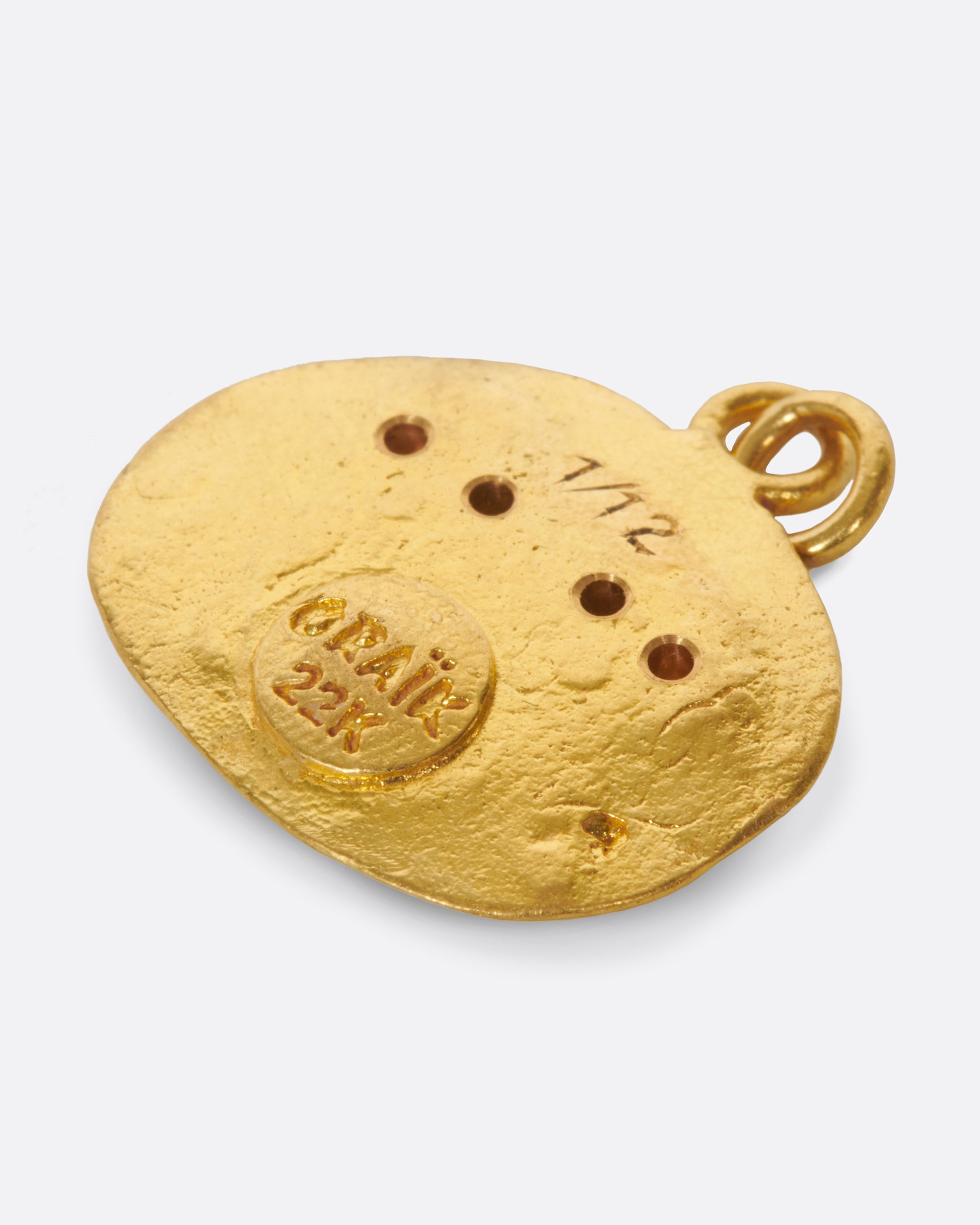 A high karat gold medallion pendant with a pair of hand-sculpted Gemini twins.