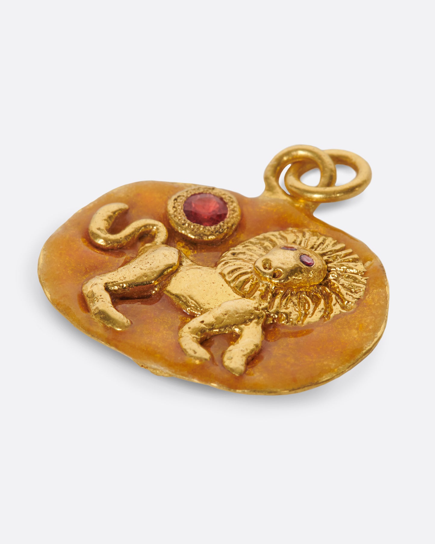 A high karat gold medallion with a hand-sculpted Leo icon with ruby eyes.