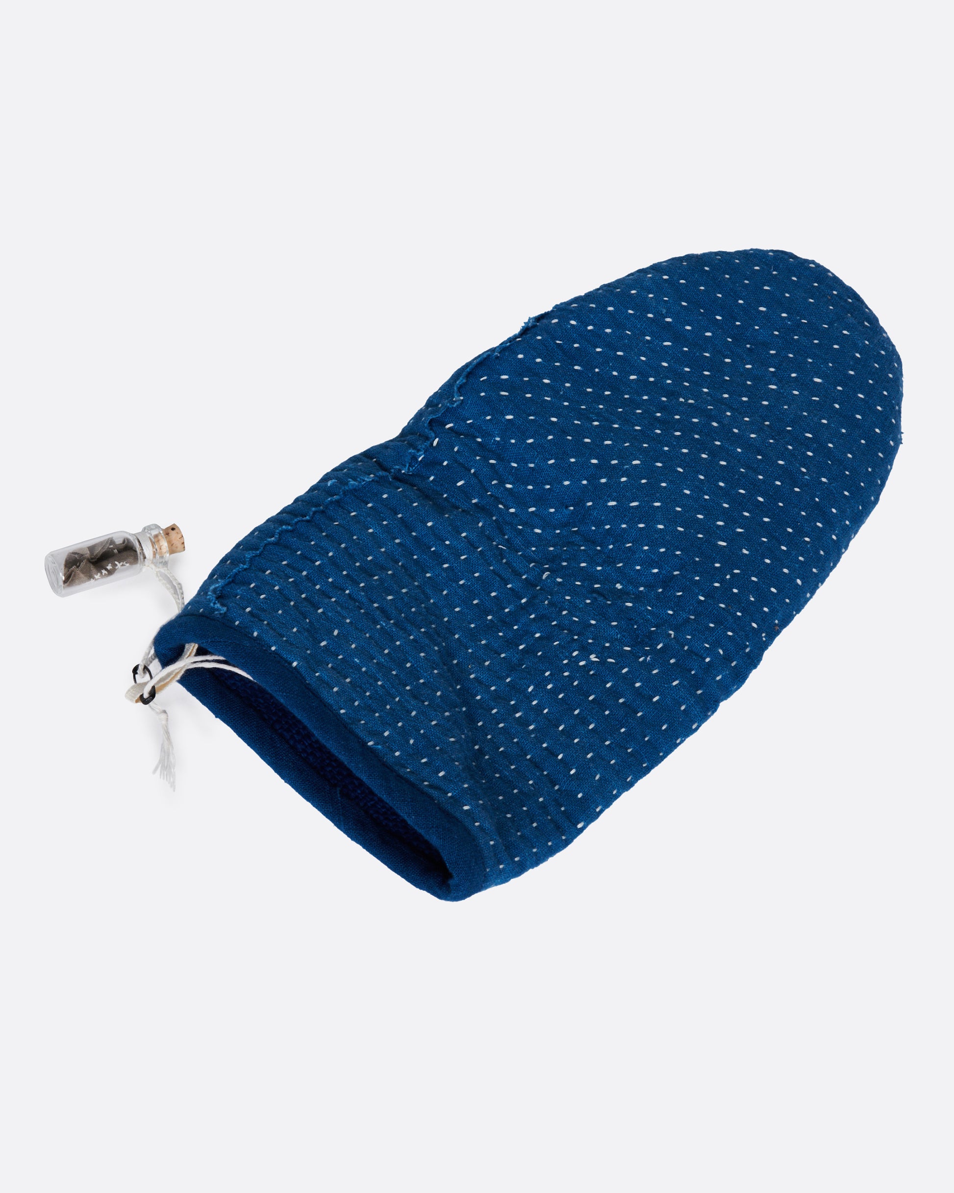 A blue hand stitched oven mitt.