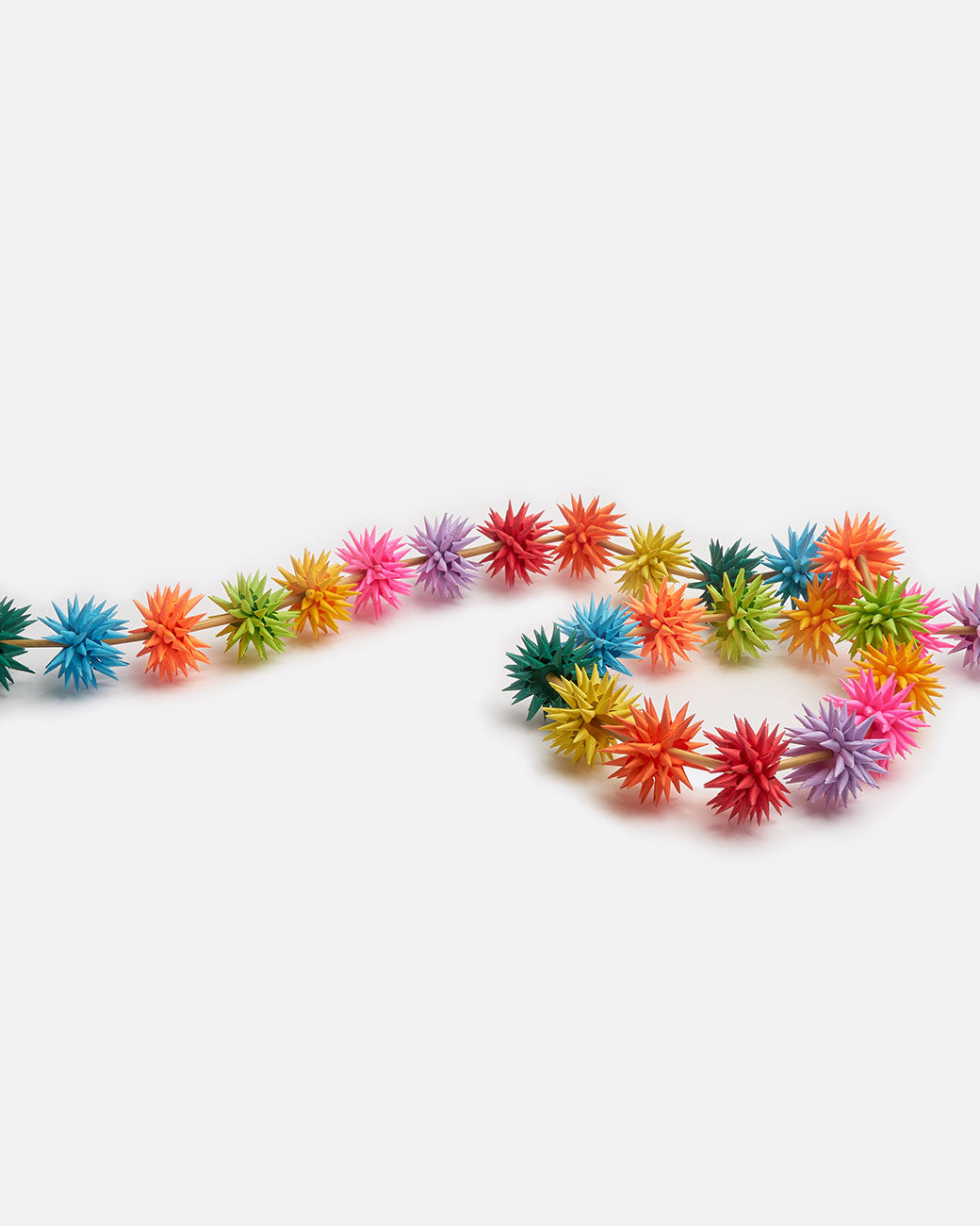 A multicolor paper starburst garland, shown from above.