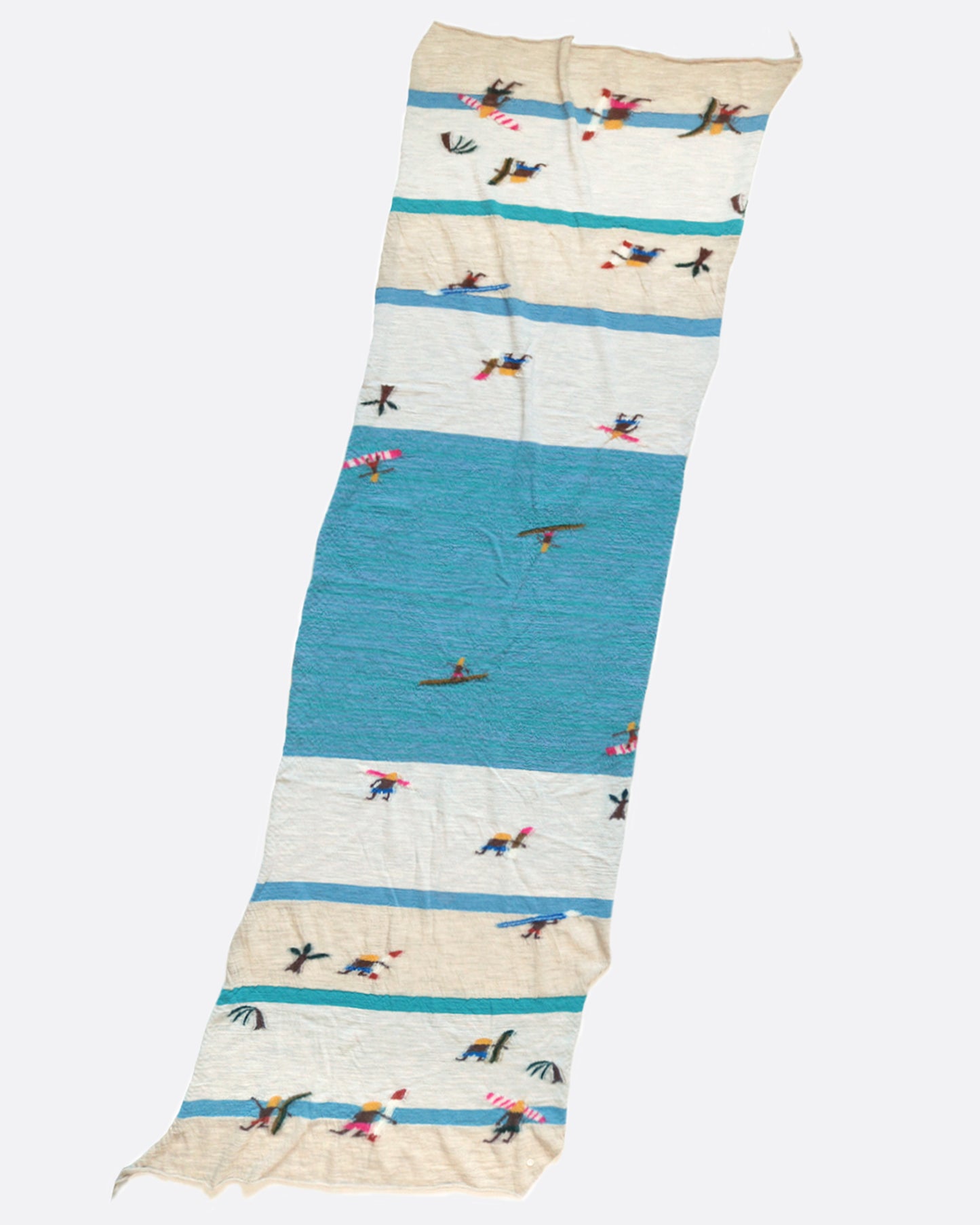 A compressed wool scarf with a fun pattern of surfers on a sandy beach.