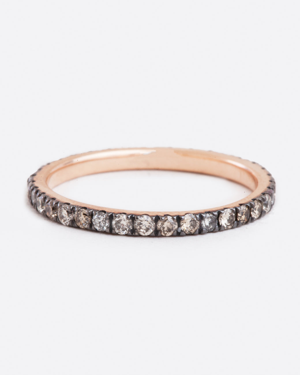 straight on view of a rose gold eternity band from designer selin kent featuring champagne and grey diamonds in varying shades