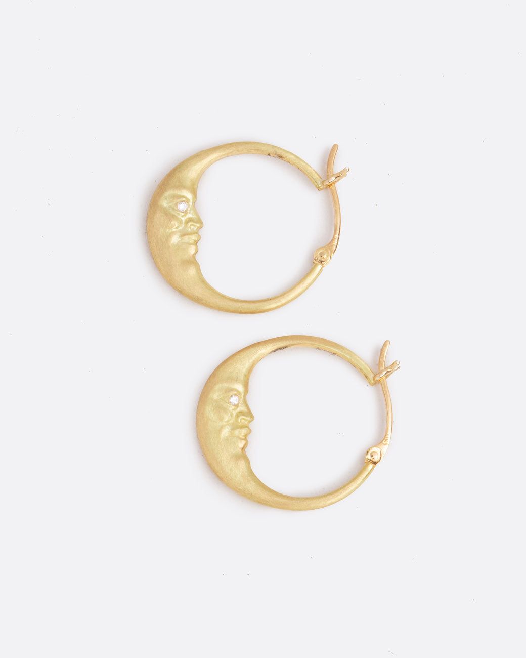 a pair of hoops that begin as crescent moons and extend into an earring hook