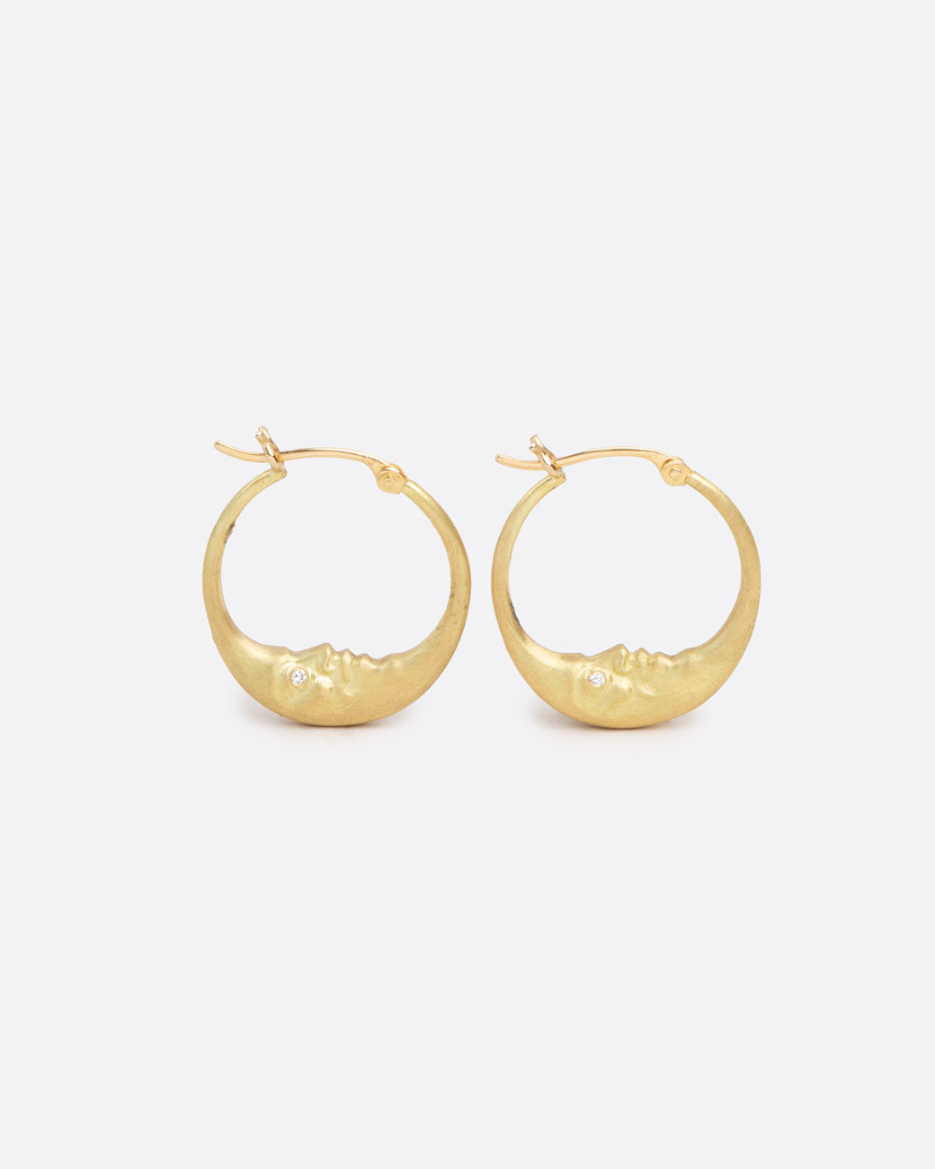 a pair of hoops that begin as crescent moons and extend into an earring hook