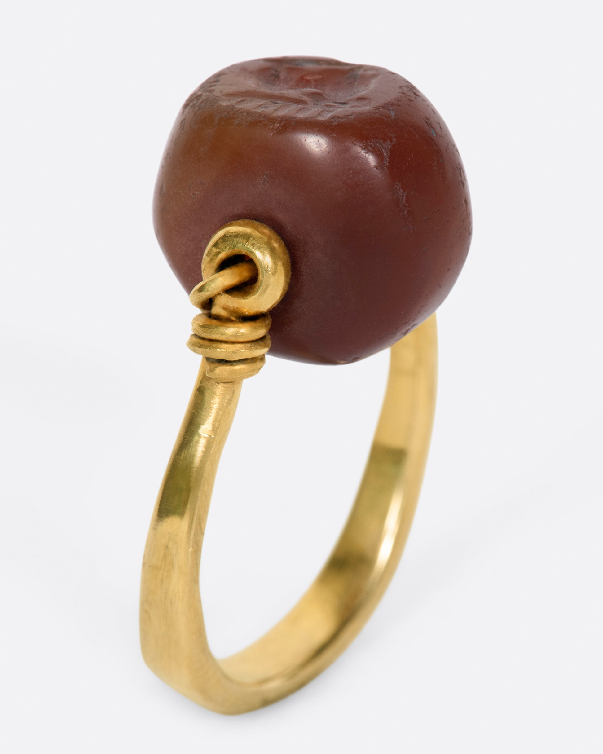 yellow gold ring with a carnelian stone that flips over and a stag carved into it