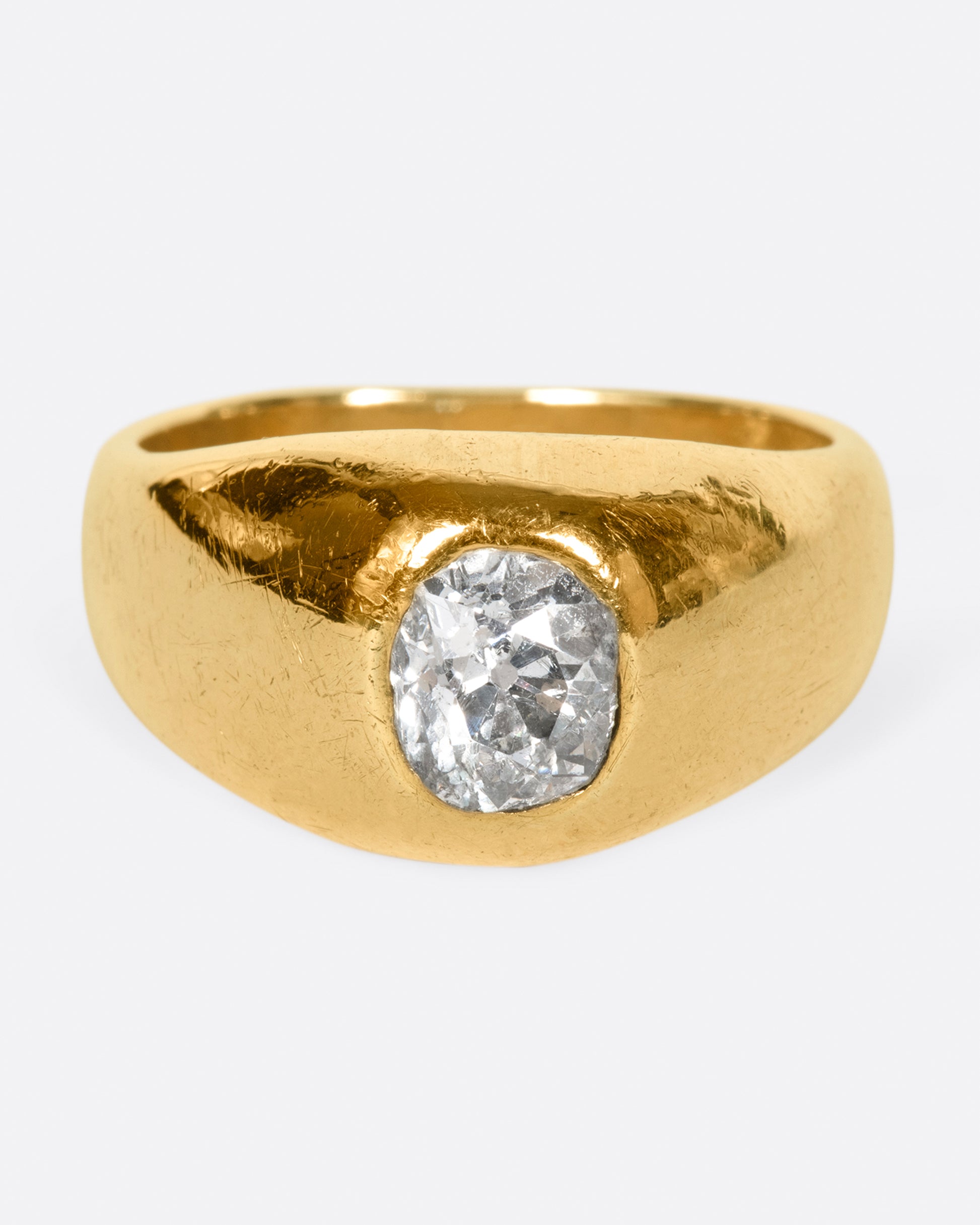 A classic, vintage dome ring with an oval old mine cut diamond sunk into the top of it.