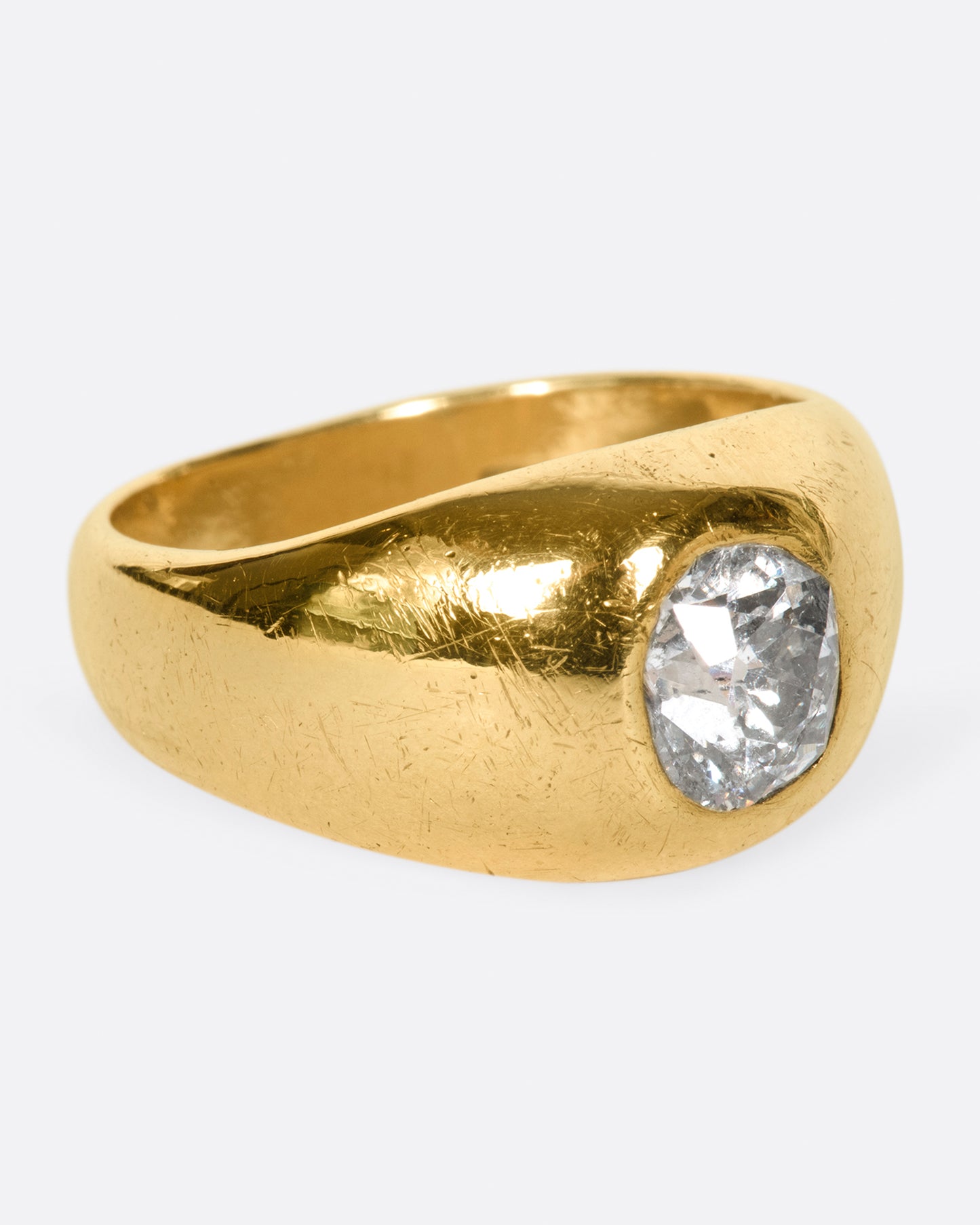 A classic, vintage dome ring with an oval old mine cut diamond sunk into the top of it.