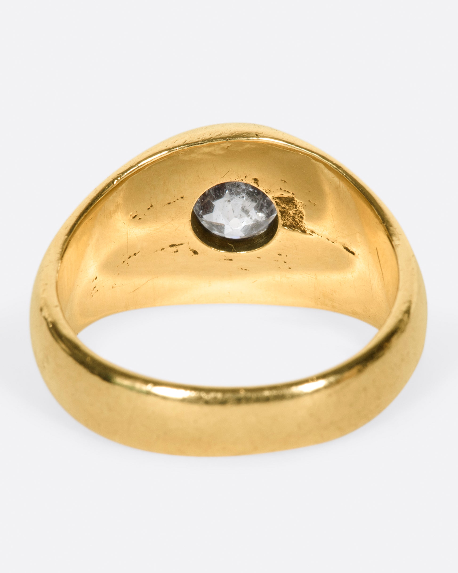 A classic, vintage dome ring with an oval old mine cut diamond sunk into the top of it.